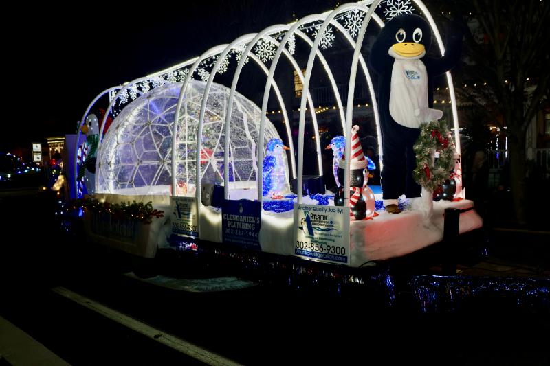“Coolie” from Atlantic Refrigeration waves to the crowd from the float that won first place in the commercial category.