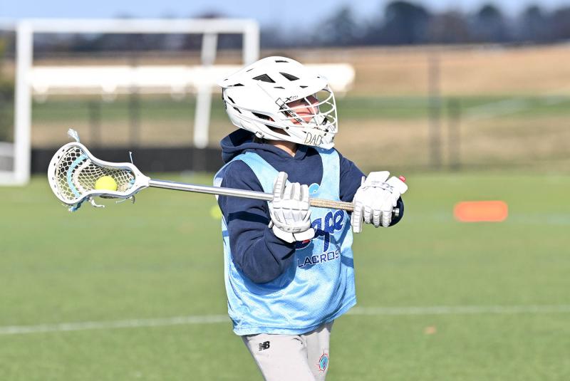 Ellendale Renegades middie Pierce Conway looks to pass to the crease in the championship game with Stephen Decatur Maryland Boys.