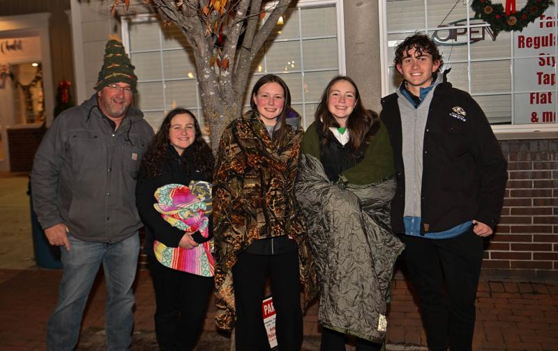 Staying warm for Santa’s arrival are (l-r) Robert and Mary Downs, Katie and Madison Jones, and Quinn Downs.