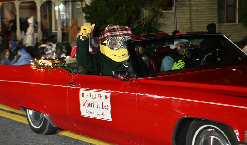 Sussex County Sheriff Robert T. Lee drives a classic car while a Minon, aka Mr. Pepper, entertains the crowd.