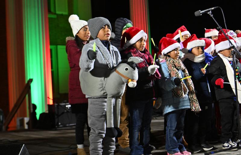 The Children’s Choir of St. Michael’s Catholic Church performs for the crowd gathered for the Caroling on The Circle.