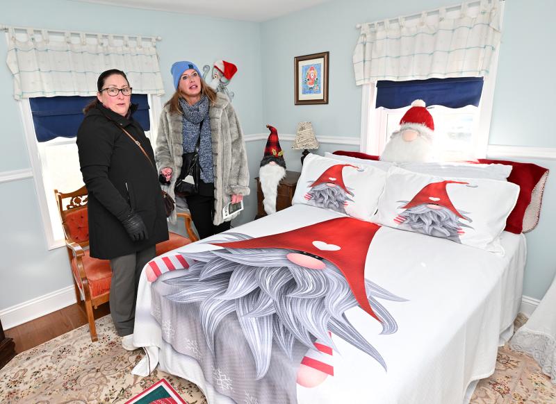 Sue D’Andelet, left, and Michelle Cole admire the gnome-decorated house of Deb and Jack Tyson at 313 Savannah Road.