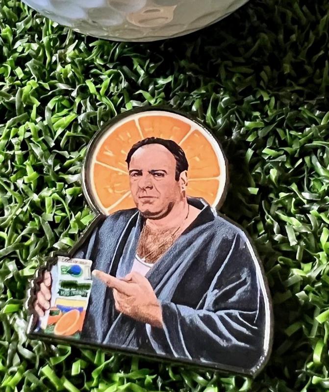 The Jersey Boss ball marker is an homage to the Sopranos, where golf was an occasional part of the gang activity. Bada bing, indeed.