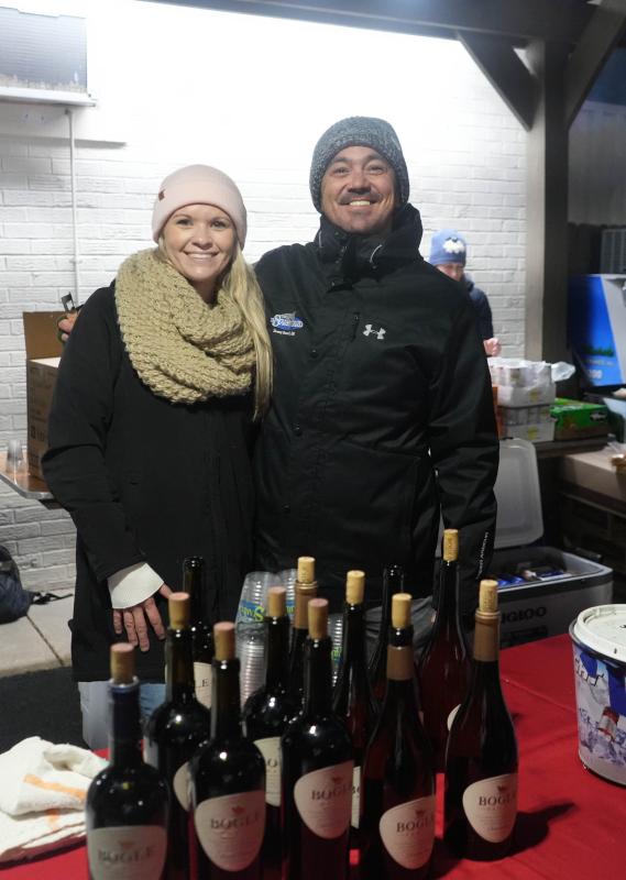 Katlynn Warner, left, and Doug Moore, employees at The Starboard, volunteer at the Dewey Business Partnership Christmas tree lighting.