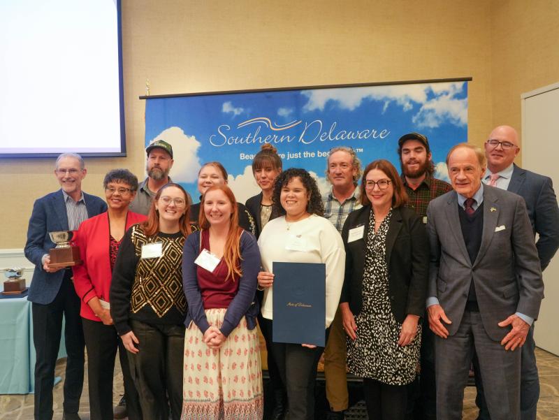 James Farm Ecological Preserve was named Best Attraction. Shown are in back (l-r) Mark Carter, Maddie Fox, Lisa Daisey, Bob Collins, Morgan Krell and Sen. Russ Huxtable. In front are Delaware Center for the Inland Bays Executive Director Christophe Tulou, past SDT Chair Bonnie Hall, Caitlin Chaney, Marina Feeser, Nivette Perez-Perez, Rep. Claire Snyder-Hall and Sen. Tom Carper.
