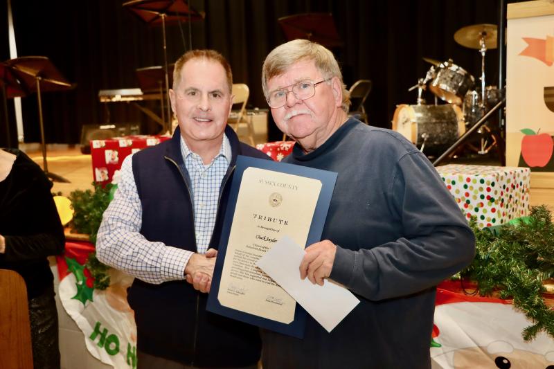 Sussex County Councilman Mark Schaeffer, left, presents Chuck Snyder with a tribute on behalf of council.