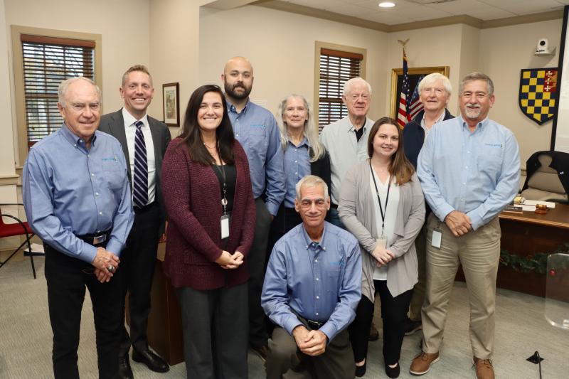 The Lewes Board of Public Works honored Austin Calaman, outgoing general manager, at its Dec. 12 meeting. Calaman is leaving for family reasons. He is taking a similar job in Pennsylvania. Shown are (l-r) Preston Lee, board member; Mike Hoffman, legal counsel; Sharon Sexton, special projects coordinator; Austin Calaman, general manager; Barbara Curtis, board member; Tom Panetta, board president (kneeling); Richard Nichols, board member; Kimberly Bellere, finance director; Bob Heffernan, board member; and Robin Davis, assistant general manager. BILL SHULL PHOTOS