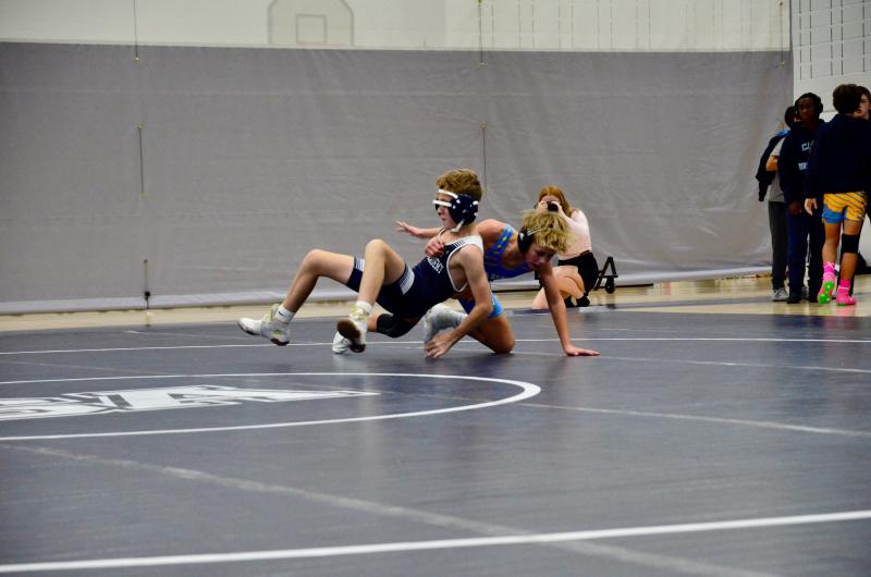 Sussex Academy seventh-grader Liam Clark tries to sit and escape the grasp of Beacon seventh-grader Brodie Godbout.