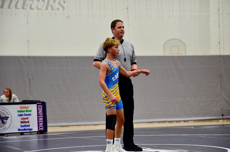 Beacon seventh-grader Brodie Godbout is presented as the winner to a nearly packed house watching the first home match for the middle school wrestling team at Sussex Academy.