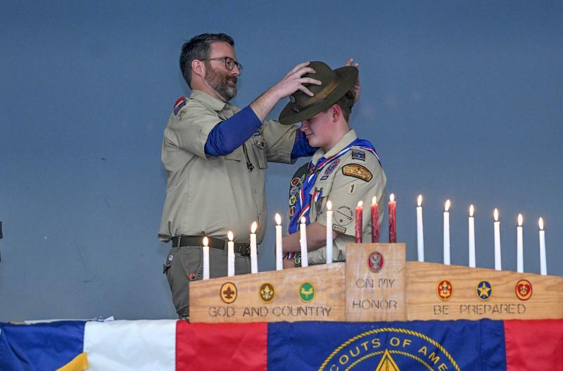 Former Troop 1 Scoutmaster John Murray presents Ian Campbell with a campaign hat that was a gift from Eagle Scout William Smith.