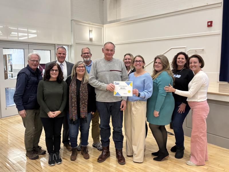 Officials from the Sussex Consortium, the Cape district and the school board present the Cape Community Champion Award to Dolle’s Candyland and owner Tom Ibach Jan. 23 at Milton Elementary. Shown in back are (l-r) Sussex Consortium job coach Doug Gardner; Superintendent Bob Fulton and job coaches David Wimer and Christina Strunk. In front are job coaches Julie Bernheimer and Dee Meade, Tom Ibach, Sussex Consortium Principal Vivian Bush, job coach Stacey Jones, Sussex Consortium vocational coordinator Pamela Graves and board President Alison Myers. ELLEN MCINTYRE PHOTO