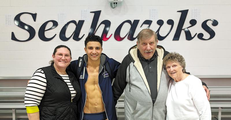 After breaking Sussex Academy’s school record in the 50 freestyle last January with a time of 22.82 seconds, Christian Wright posed with his mom Kimberly, left, and grandparents John and Mina Wright. All three are relieved that Christian has been able to work his way back.