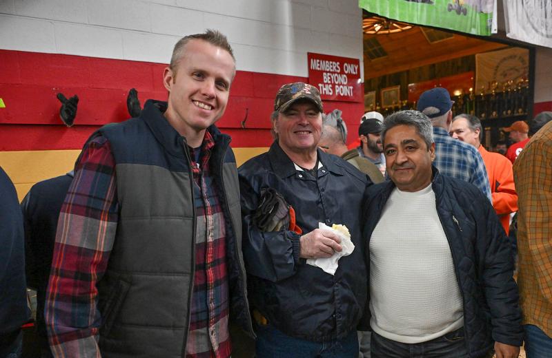 John Parker Jr., left, and his father John Sr. attend the event with their friend Sait Acar from Adliswil, Switzerland, where he is also a volunteer fireman.
