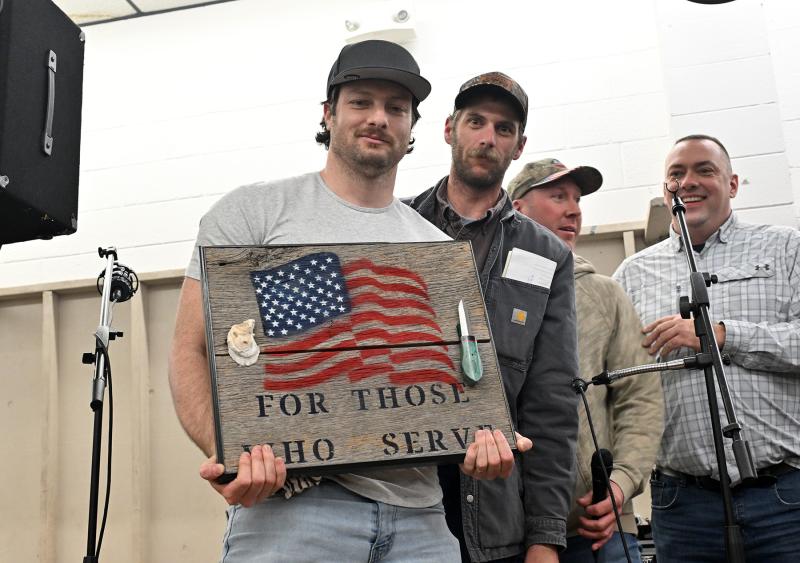 Lawrence Urgo of Virginia had the winning bid of $3,500 for the homemade knife made by Rocky and Neal Greene. Urgo has purchased three over the last few years. Shown with Urgo are (l-r) Sean McGee, Michael Briggs and Sen. Brian Pettyjohn, R-Georgetown.