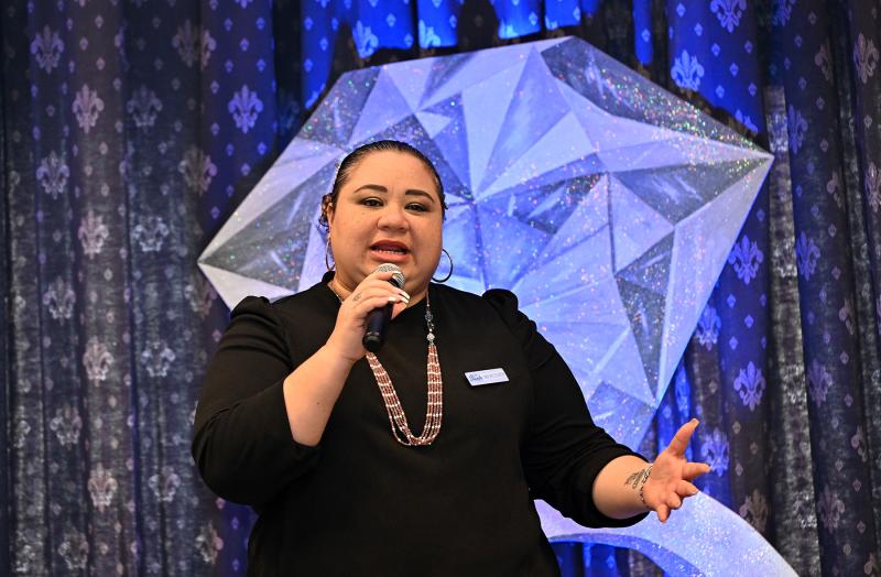 Atlantic Sands Hotel Events Director Merecedes Sobalvarro speaks to the crowd about the importance of quinceañera.