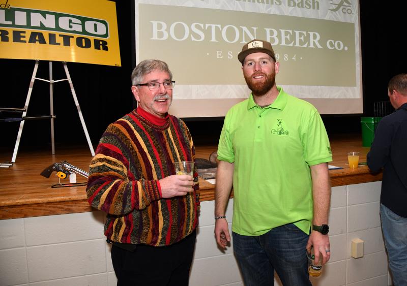 Having a conversation and a libation are Ducks Unlimited members Sanford Hazzard, left, and Mike Bateman.