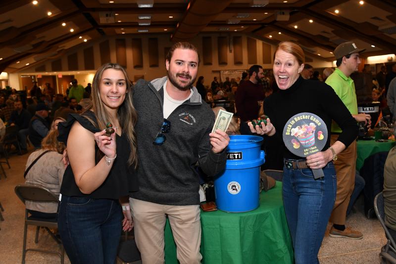 Evan Urgo, center, purchases ducks for the Duck in a Bucket game from Rylee Ridgeway, left, and Carrie Lingo.