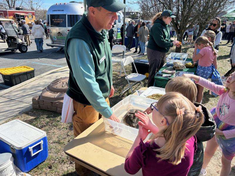 Richard Julian of Cape Henlopen State Park shows off the anatomy of a horseshoe crab to curious kids.