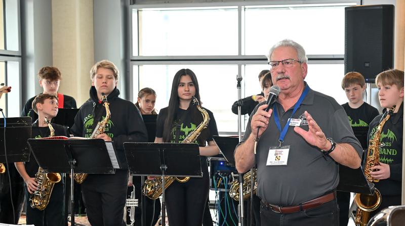 Paul Kares director of development Fran Simeone introduces the Southern Delaware School of the Arts rock band.