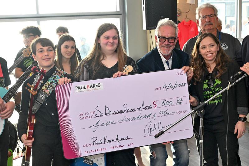 Paul Cullen presents a $500 check to members of the Southern Delaware School of the Arts rock band. Shown are (l-r) Luke O'Boyle, McKenna Neumann, Haylie Hudson, Paul Cullen, SDSA teacher Melody Oneschuk and Paul Kares director of development Fran Simeone in back.