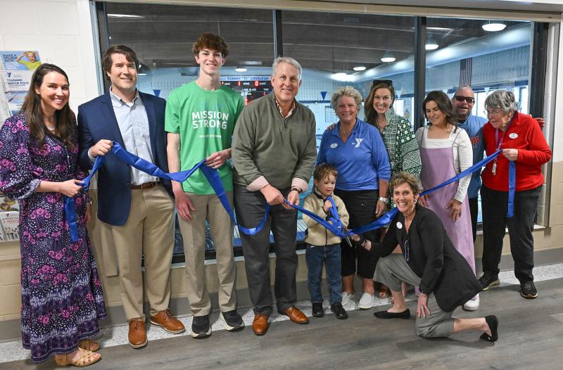 Tommy Coveleski’s great-nephew Cooper, 4, cuts the ribbon at the scoreboard dedication. Shown are (l-r) Kristen Canatelli-Coveleski, Josh Coveleski, Brady Schell, Preston Schell, Cooper Coveleski, YMCA board member Tina Maddox, Kathleen Schell, Sam Coveleski-Mazur, Mike Elentrio, YMCA board member Mary Bruno and (kneeling) YMCA of Delaware Community Vice President LoriKay Paden. DAN COOK PHOTOS