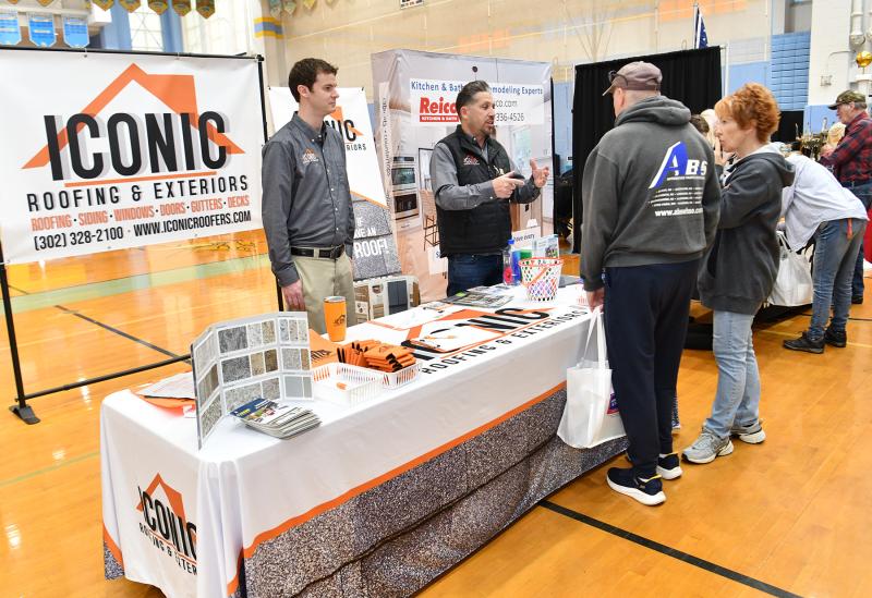 Shawn Dupuis and Marc Hannum of Iconic Roofing and Exteriors explain their systems to George and Lori Celia.