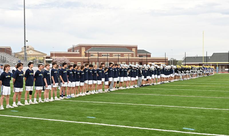 Cape and Caesar Rodney gather before the game to observe a moment of silence for Ryan Andrew and Elijah Ghabour.
