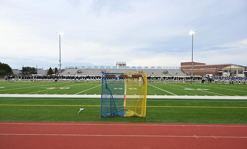 Cape and Caesar Rodney gather before the game for a moment of silence for Ryan Andrew and Elijah Ghabour. The blue-and-gold goal was on the side of the field during the game.