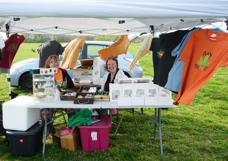 Vendors Laura Shipkowski, left, and Gail O’Connor are ready for customers. They sell shirts, cannabis-infused products and edibles, along with other wares.