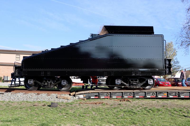 The tender is rolled off the truck and onto the track. A Delaware sign company will apply titles to the sides in the next couple of weeks.
