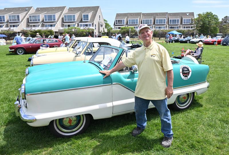Christopher Custin of Milford stands with his 1960 Nash Metropolitan 561. This auto was produced in England for just $300.
