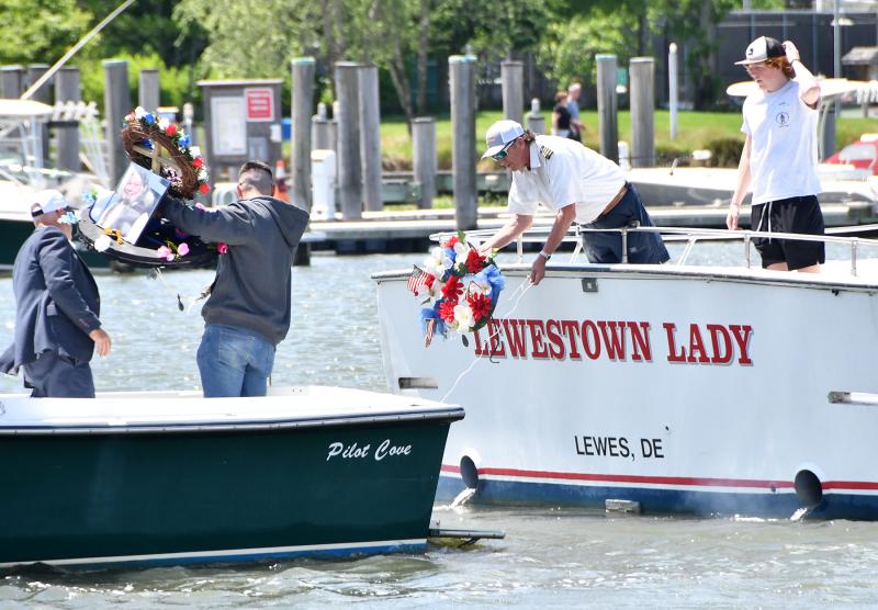 Family members and mates place the memorial wreaths into the water. Shown are (l-r) Capt. Bryson Walsh, his crew member Bryson Jr. on the Aquatic Narcotic, and HD Parsons and Matt Tarbox on the Lewestown Lady.