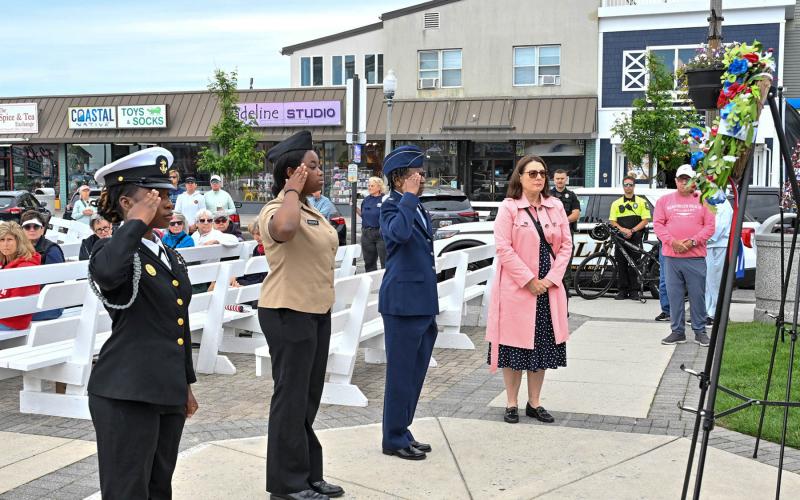 Saluting the wreaths are (l-r) Seaford High School JROTC cadets Laura M. Charles and Fabrima Prosper, retired Air Force Maj. Dana Paskins and Rep. Claire Snyder-Hall, D-Rehoboth Beach.