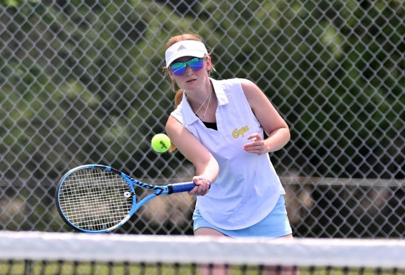 Cape’s third-singlesplayer Kathryn Cosatello pops a volley in her 6-3, 6-3 win over Dover’s Kalisa Chambers in the semifinals.