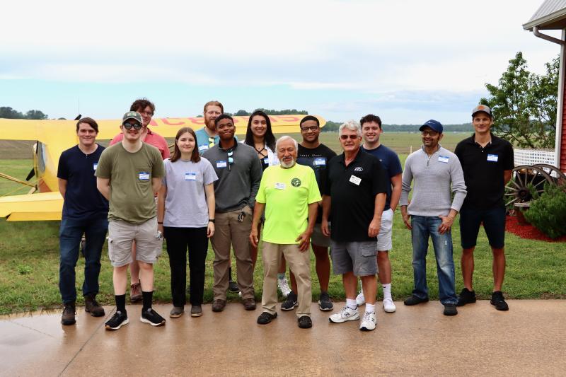 Some of the potential future aviators paused for a photo with John Chirtea, in yellow shirt, who is vice president of EAA Chapter 1683, and Drew Mungo, Chapter 1683 president. The day started out gloomy, but when it cleared off, 12 future aviators were able to go for rides.