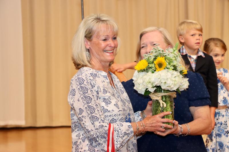 Judy Schrader, Penguin teacher, receives flowers from Director Betsy Plowman. Schrader is stepping down from teaching at Epworth after 28 years. She will still be the administrative assistant.