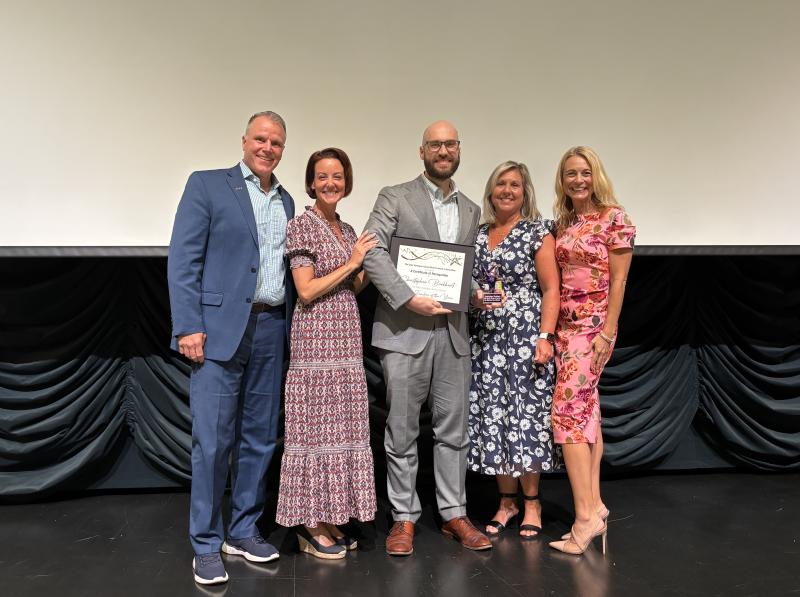 Cape High’s band director, Chris Burkhart, was named the school district’s 2025-2026 Teacher of the Year at a ceremony on May 14. Pictured (l-r) are Superintendent Bob Fulton, Board Member Alison Myers, Burkhart, Director of Teaching & Learning Lou Ann Hudson and Assistant Superintendent Jenny Nauman. ELLEN MCINTYRE PHOTO