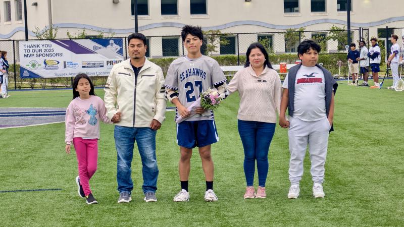 Josh Jovel-Velasquez walks across with his family on a field that the senior rarely leaves when the game is in full swing.
