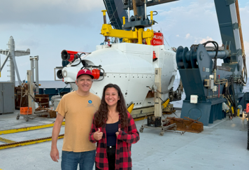 Andrew Wozniak, left, and Alyssa Wentzel, a University of Delaware student, in front of the Alvin, shortly before the dive where they witnessed the aftermath of the volcanic eruption. PHOTO COURTESY ANDREW WOZNIAK