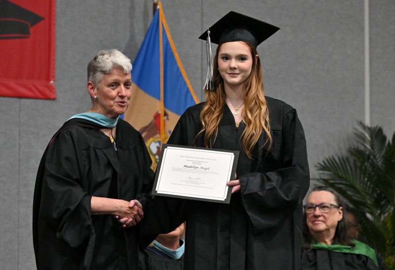 Madelyn Angil receives the State of Delaware Department of Education Scholarship from Delaware Director of Adult Education Maureen Whelan.