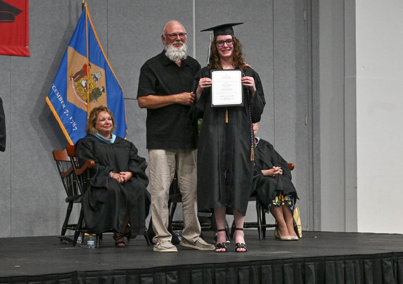 Grayson Boyette receives the Ethel Cook Memorial Scholarship from Cook’s son Daniel, a former Groves teacher. Ethel Cook graduated from Groves at 79 years old. SUBMITTED PHOTO