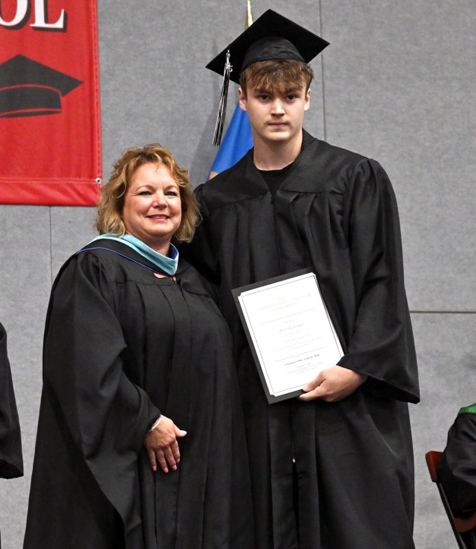 Andrew Joseph receives the 2025 Adult Education scholarship from Groves Director of Adult Education Kelly Whaley.
