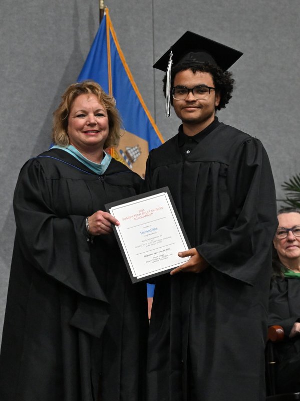 Michael Gibbs receives the Sussex Tech Adult Division Scholarship from Groves Director of Adult Education Kelly Whaley.