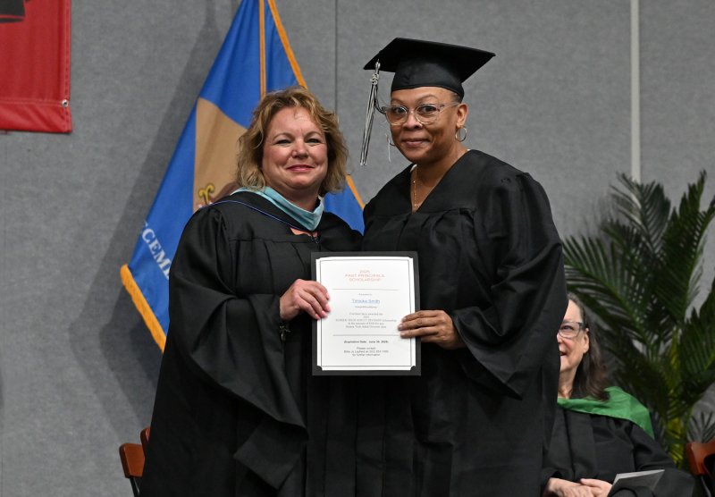 Groves grad Timicka Smith receives the Sussex Tech Adult Division Scholarship from Groves Director of Adult Education Kelly Whaley.