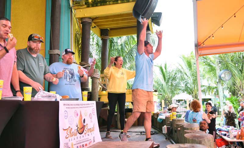 Bryan Sears, chief operating officer of Paradise Companies, gets the crowd pumped during the hot dog-eating contest.