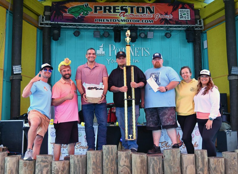 Big Mike took first place in the hot dog-eating contest. Shown are (l-r) Bryan Sears, chief operating officer of Paradise Companies; Ryan Stevenson, founder and owner of Shore Smoke Seasoning; Chris Turnbull, runner-up; Big Mike McLean, winner; Justin Paulson, third-place finisher; Barbara Ann Racine-Kerezsi, event director for Paradise Companies; and Anna Gravatt, marketing rep for Paradise Companies.
