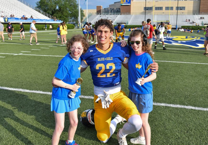 Blue team member Ryan Tattersall (Wilmington Friends) gets a pregame good luck hug from his buddies Autumn, left, and Samantha Bender.