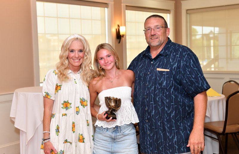 Abi Crouch receives the Unsung Hero Award from assistant coach Allison Sullivan, left, and coach Mike Tkach.