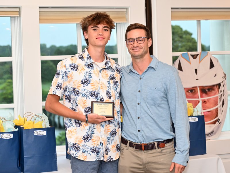 Junior varsity assistant coach Andrew Scrutchfield presents the JV Unsung Hero award to Peyton Vied.