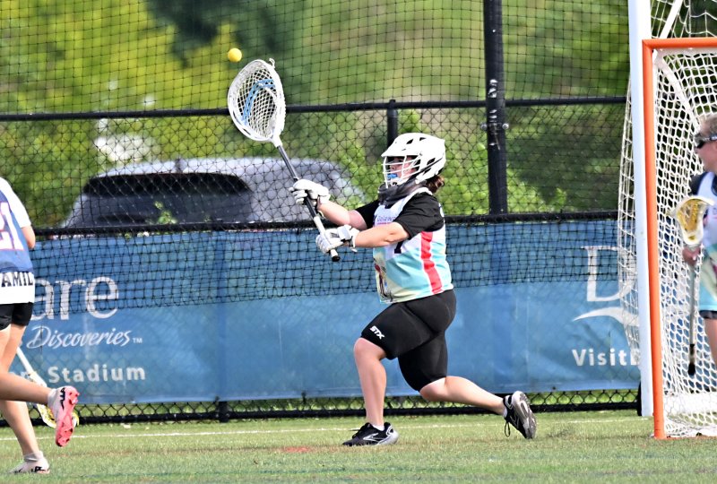 Cape grad and White team goalie Abigail Schaeffer heaves a clear after making one of her nine saves.